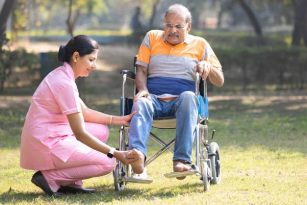 Senior man making physiotherapy session with young nurse.